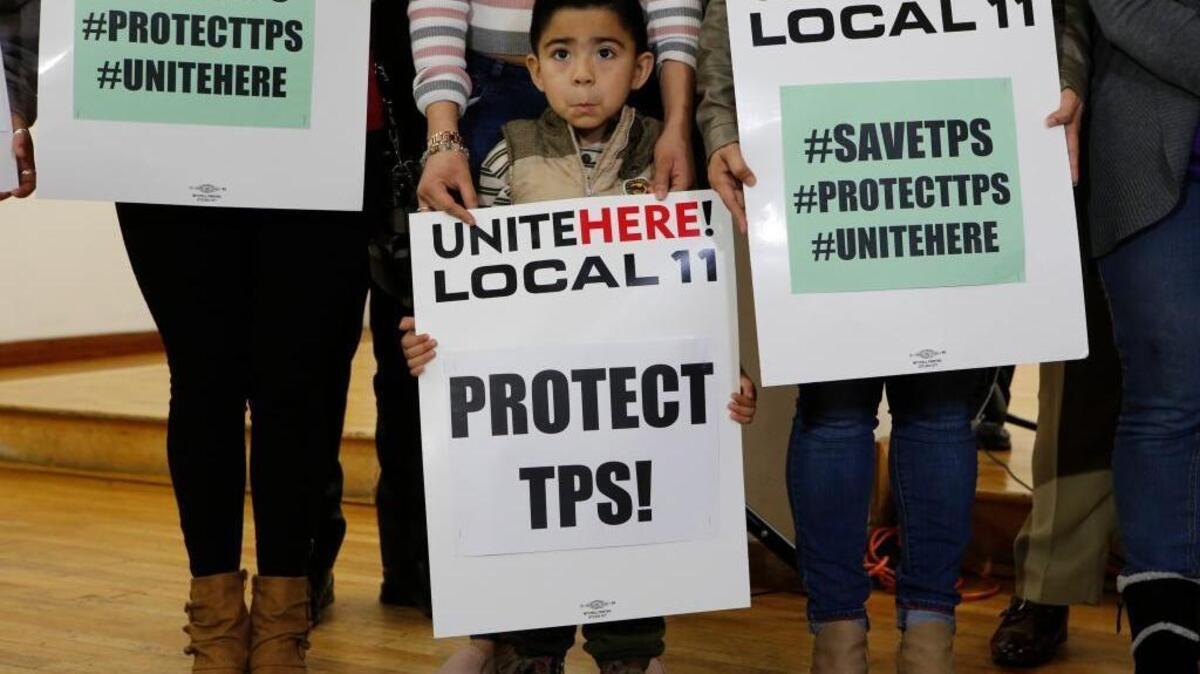 Four-year-old Mateo Barrera, whose family members are in the U.S. under temporary protected status, holds a sign at a news conference Monday, Jan. 9, 2018, in Los Angeles. The Trump administration said Monday it is ending the special protections for Salvadoran immigrants, an action that could force nearly 200,000 to leave the U.S. by September 2019 or face deportation. (AP Photo/Damian Dovarganes)