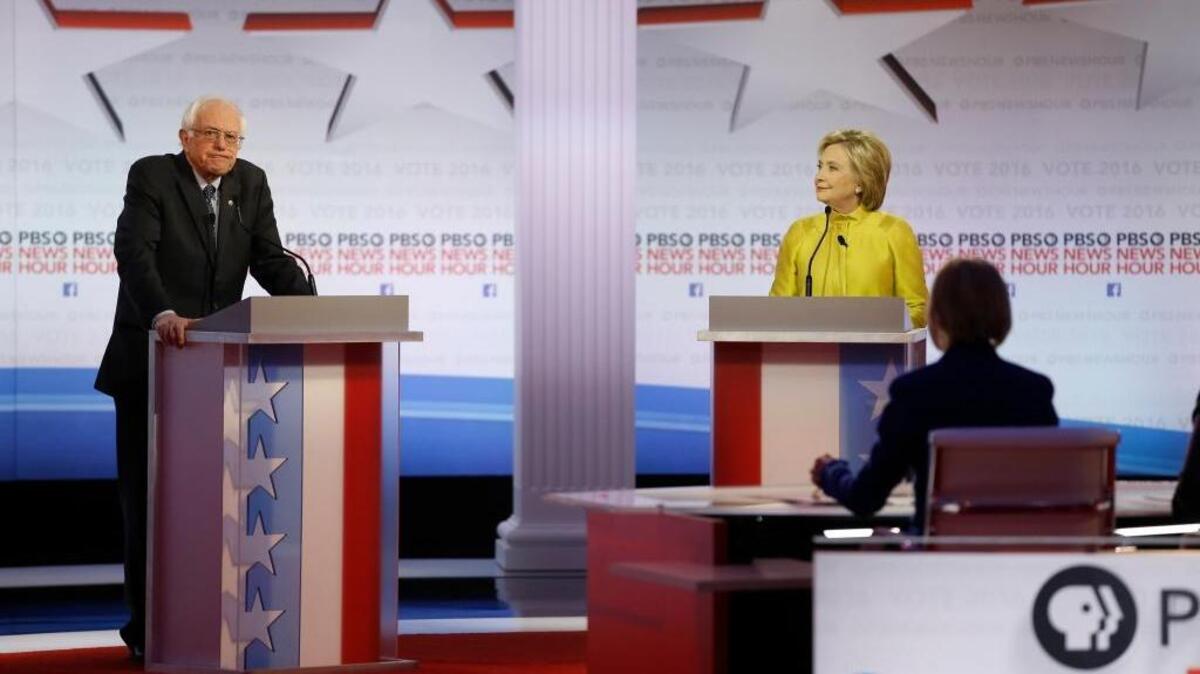 Democratic presidential candidates Bernie Sanders and Hillary Clinton appear during a Democratic presidential primary debate at the University of Wisconsin-Milwaukee on Friday.