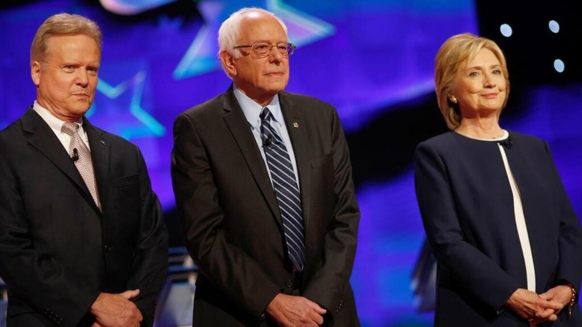 
From left, Jim Webb, Bernie Sanders and Hillary Clinton await the start of the first Democratic presidential debate in Las Vegas on Tuesday. 
