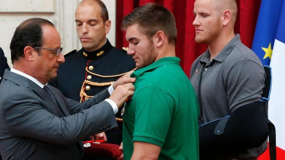 
French President Francois Hollande awards the Legion of Honor to Alek Skarlatos last week. Hollande also pinned the Legion of Honor medal on Spencer Stone, at right, Anthony Sadler and British businessman Chris Norman.
