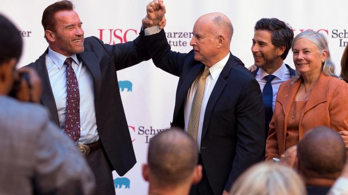 Former Gov. Arnold Schwarzenegger and Gov. Jerry Brown attend a celebration of the 10th anniversary of Schwarzenegger signing California's landmark global warming bill, AB 32, on Wednesday. Looking on are former Assembly Speaker Fabian Nuñez, D-Los Angeles, second from right, and Sen. Fran Pavley, D-Agoura Hills, the author of AB 32.
