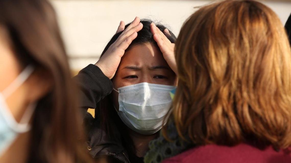 Mother of two Jennifer Lee reacts while talking to other parents protesting a massive natural gas leak with their children in Los Angeles’ Porter Ranch.