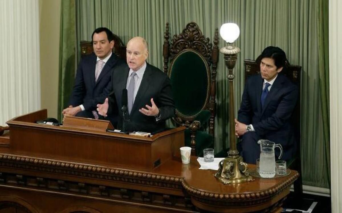Gov. Jerry Brown delivers his annual State of the State address before a joint session of the California Legislature Tuesday in Sacramento. Seated behind him are Assembly Speaker Anthony Rendon, D-Paramount, left, and Senate President Pro Tem Kevin de Leon, D-Los Angeles, right.