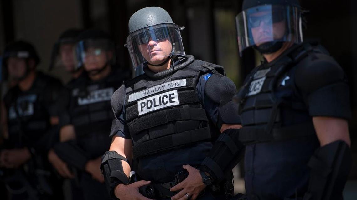 Sacramento police officers stand guard during a demonstration at the Capitol in June.