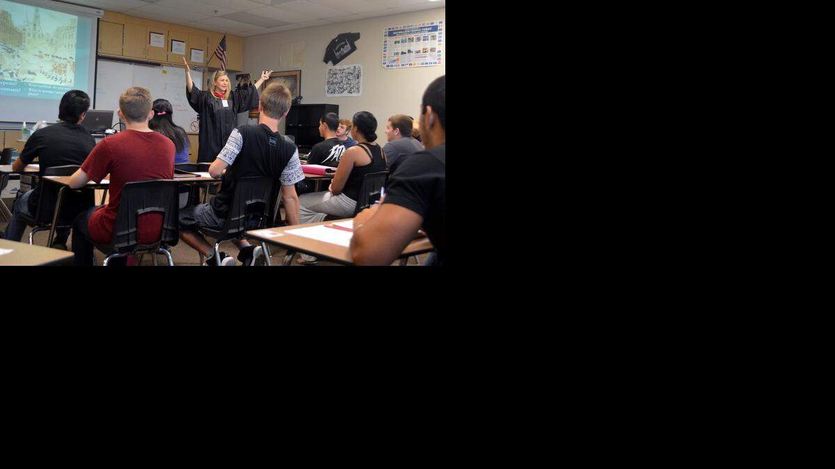 
Enochs High School history teacher Janeen Zambo, wearing a graduation robe for the campus College Day, gives a Common Core lesson on the Declaration of Independence to juniors in her U.S. History class in Modesto. Testing based on the new state standards will officially begin this spring.
