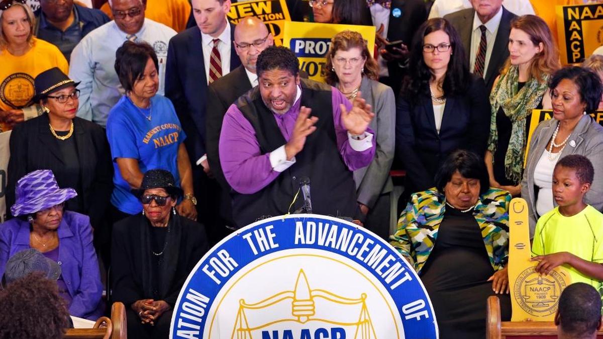 North Carolina NAACP President the Rev. William Barber, center at podium, holds a news conference in June urging a federal appeals court to block a North Carolina voter ID law. The court did so on July 29.