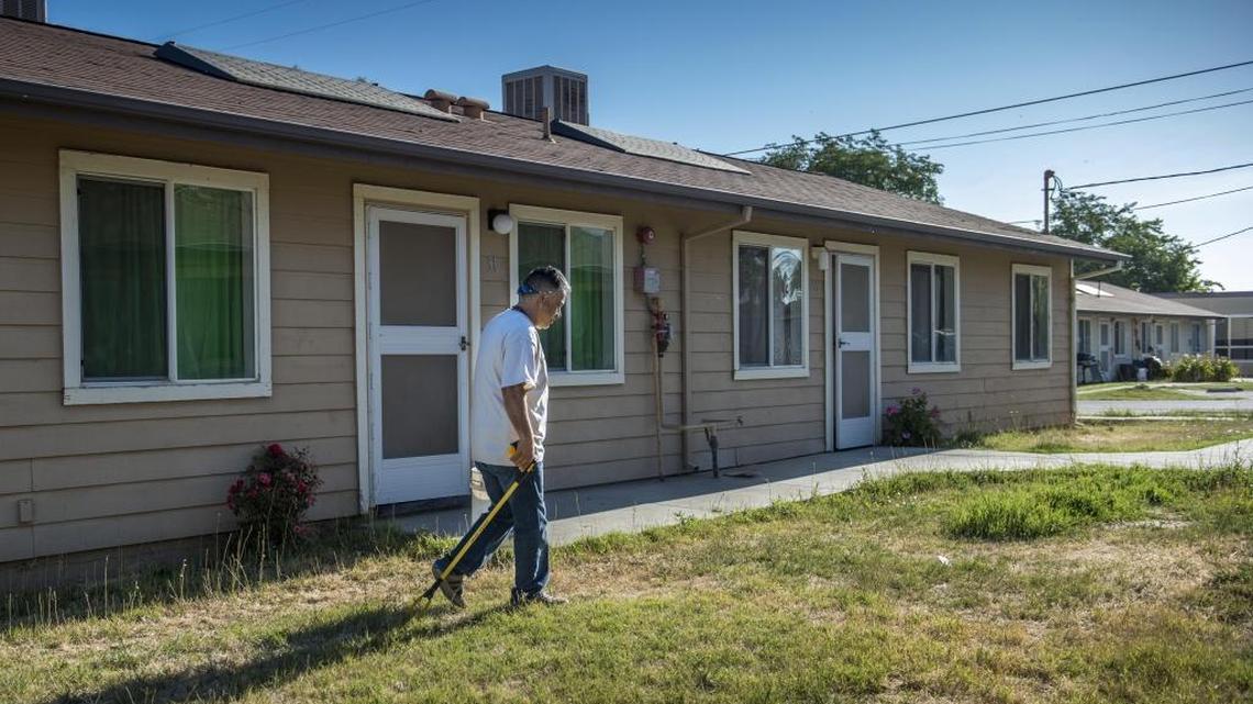 Roberto Guevara, center manager at the Davis Migrant Center in Dixon, picks up trash on July 13, 2017.