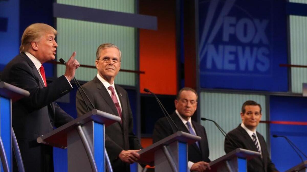 
Donald Trump speaks as, from left, Jeb Bush, Mike Huckabee and Ted Cruz listen during the first Republican presidential debate in Cleveland on Thursday.
