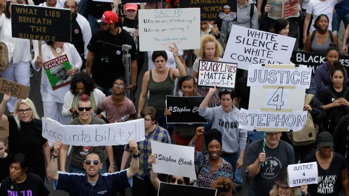Marchers calling for the indictment of two Sacramento police officers in the shooting death of Stephon Clark make their way through downtown Sacramento on April 4. When California lawmakers return from their summer recess in August, they will consider bills to restrict when police use deadly force and open some law enforcement records.