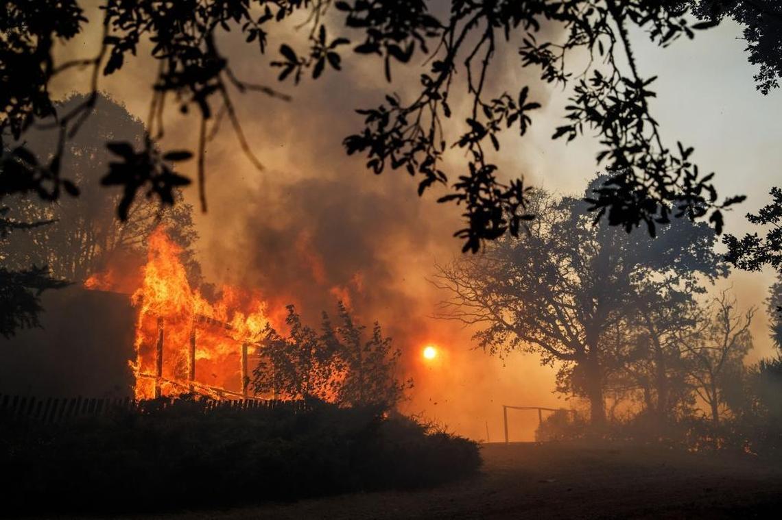 A home near Hendricks Road is engulfed in flames as the River Fire spreads, near Lakeport, Calif., on Tuesday, July 31, 2018.