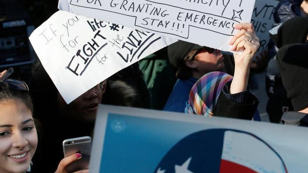 A sign at a rally Sunday in New York thanks a federal judge who ruled against President Donald Trump’s order on immigrants and refugees.