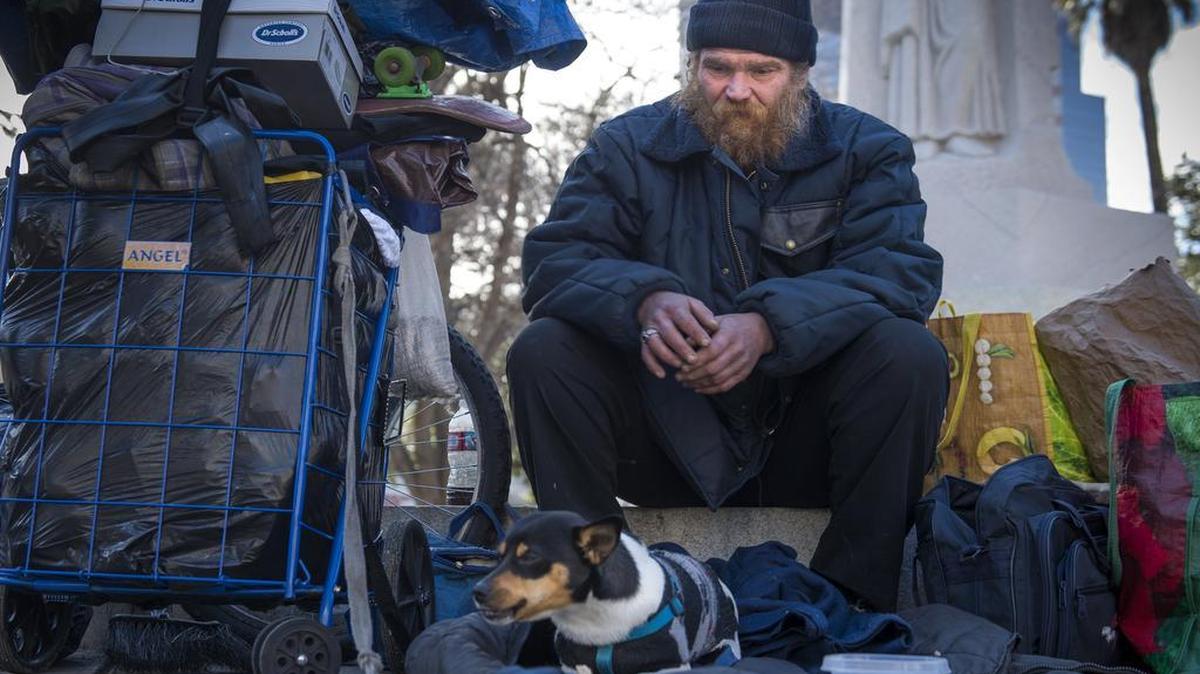 William Mercer sits with his dog Chico at Cesar Chavez Plaza. He was friends with one of the two homeless men who died this year on the grounds of Sacramento City Hall.