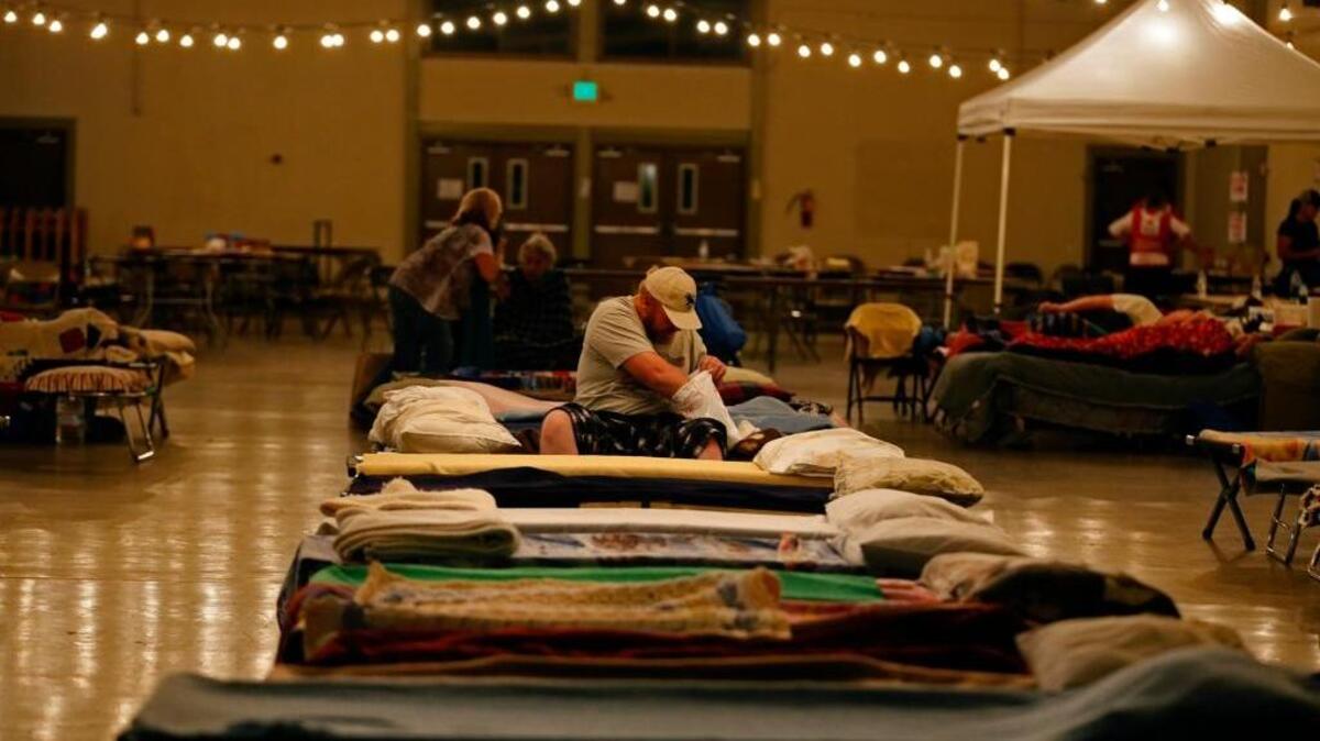 
Dave Burns digs into a Red Cross toiletries bag before bedding down on a cot at the Napa County Fairgrounds evacuation center on Sunday, Sept. 13, 2015, in Calistoga. The 50-year resident of Middletown said the fire rolled over his family’s truck and heavy equipment business.

