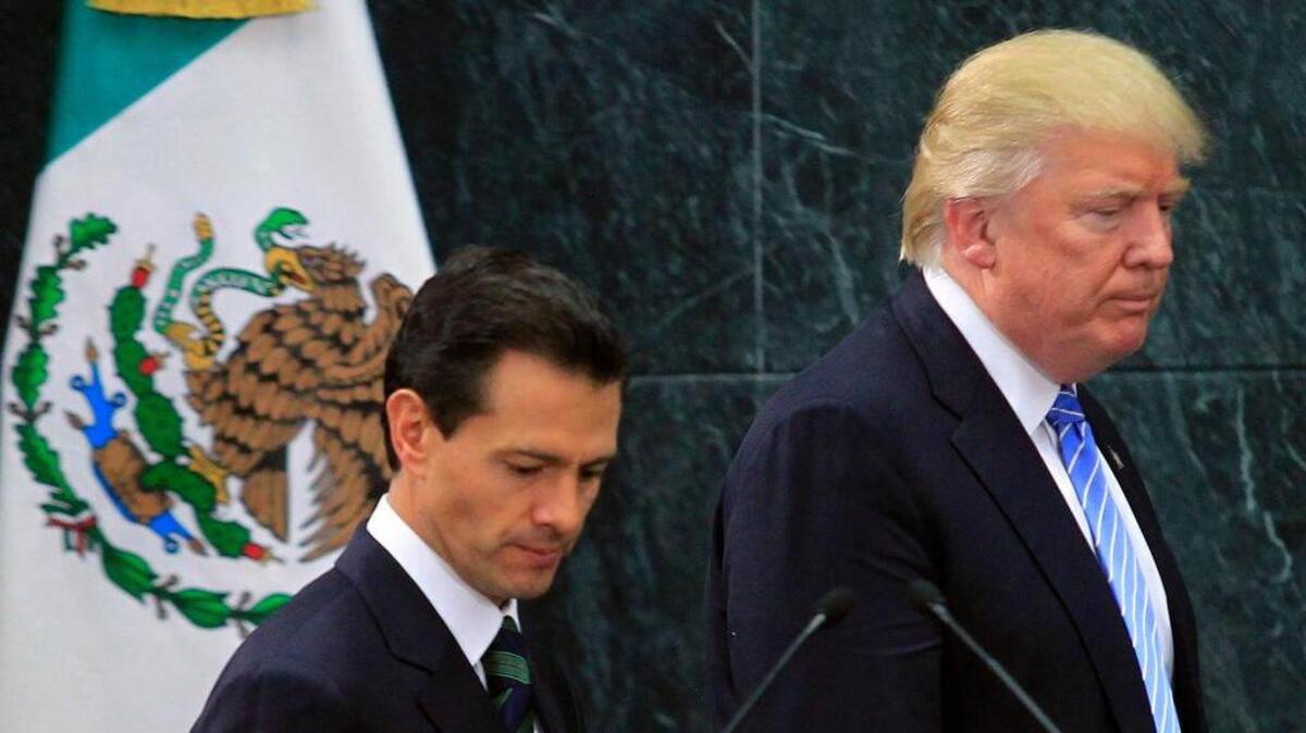 Donald Trump, right, appears with Mexican President Enrique Peña Nieto after an August meeting in Mexico City. Now as president, Trump’s executive order to immediately start construction of a border wall has widened his rift with Mexico.