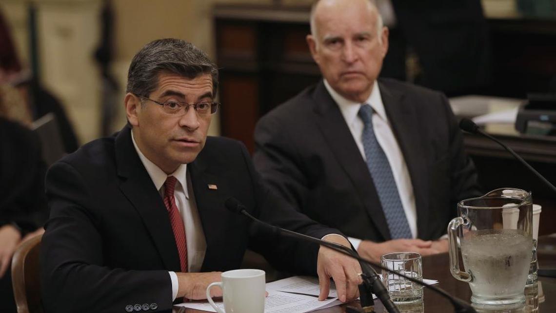 Rep. Xavier Becerra faces a confirmation hearing for attorney general, as Gov. Jerry Brown, right, looks on.