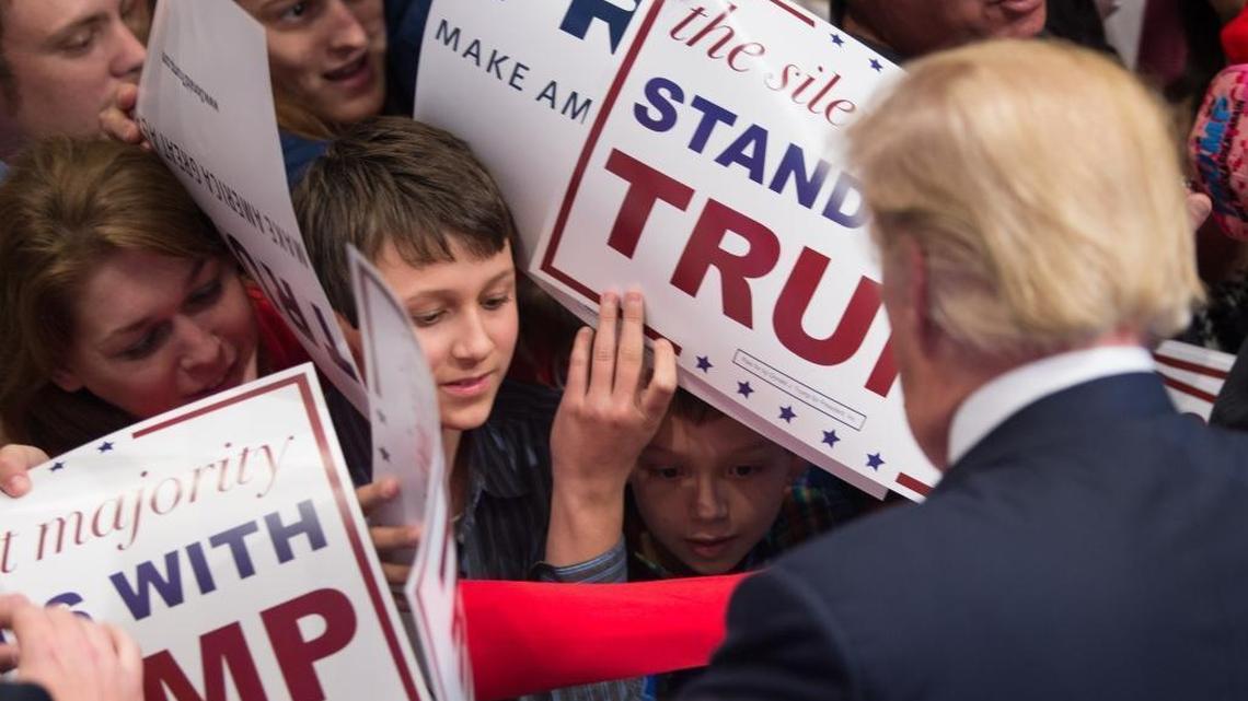 Republican presidential candidate Donald Trump signs autographs after speaking at a campaign rally Nov. 30 in Macon, Ga. Those who thought voters would tire of him have so far been wrong.