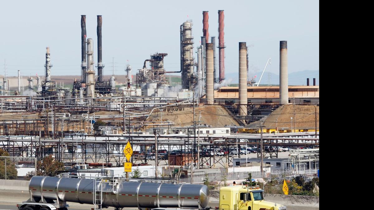 
A tanker truck passes the Chevron oil refinery in Richmond in 2010. State law requires that California reduce greenhouse gas emissions to 1990 levels by 2020 and forces heave carbon emitters to buy offsets in the cap-and-trade market.
