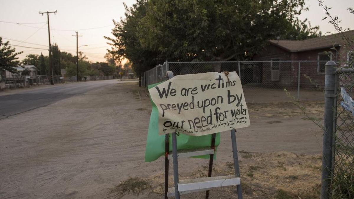 An East Porterville resident hung this sign along a street to protest a decision to get water from the city of Porterville.