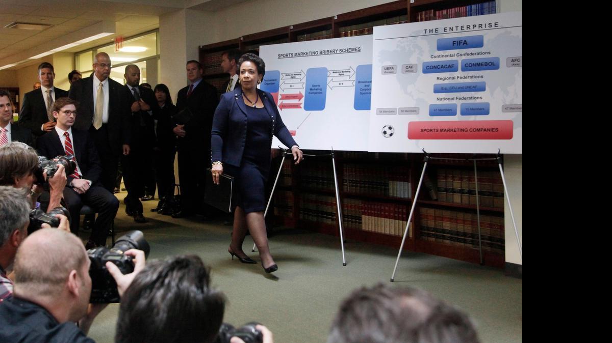 
U.S. Attorney General Loretta Lynch arrives for a news conference Wednesday to announce indictments against FIFA officials and corporate executives for racketeering, conspiracy and corruption. 
