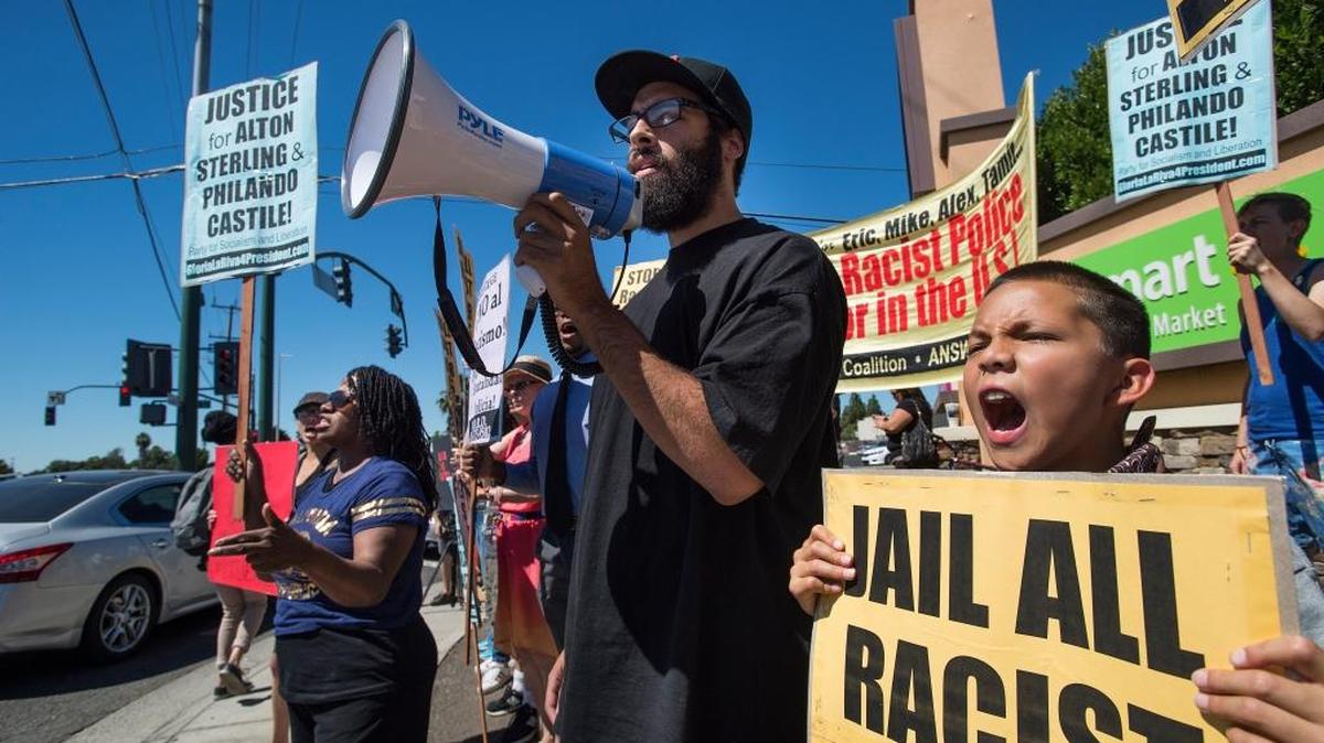 Jamier Sale of the Answer Coalition leads a chant during a Black Lives Matter rally at the intersection of Florin Road and Franklin Boulevard in South Sacramento on July 10, 2016.