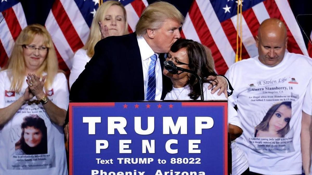 Donald Trump embraces a woman whose child was killed by an undocumented immigrant after an immigration speech Wednesday night in Phoenix.