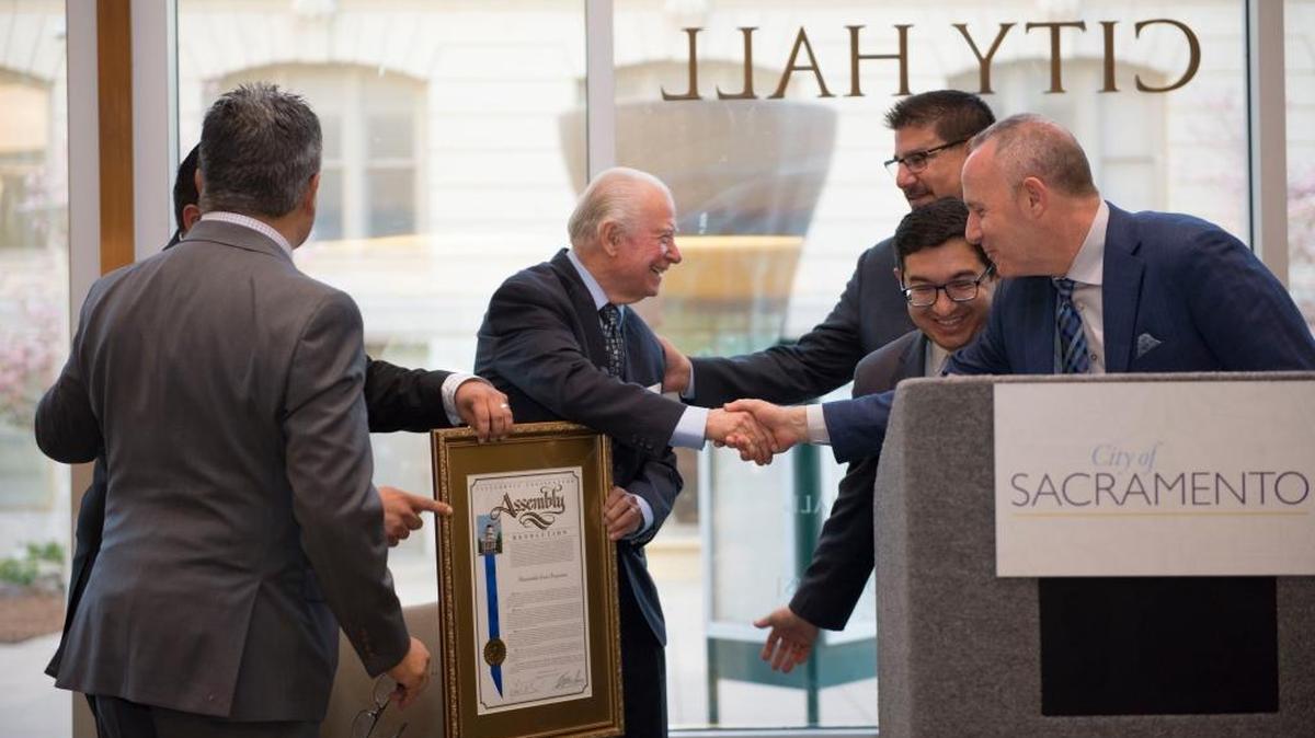 Darrell Steinberg, right, Sacramento City Councilman Eric Guerra, center foreground, and Sacramento County Supervisor Phil Serna honor Cruz Reynoso, left, the first Latino appointed to the California Supreme Court, in March 2016. The City Council and Board of Supervisors plan their first joint meetings in recent memory.