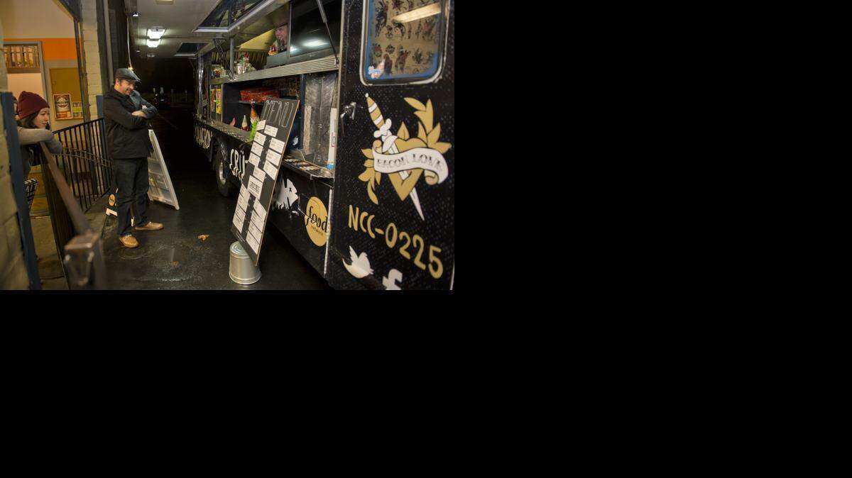 
Customers look at the menu of Keith Breedlove’s Culinerdy Cruzer food truck in Sacramento last November. 
