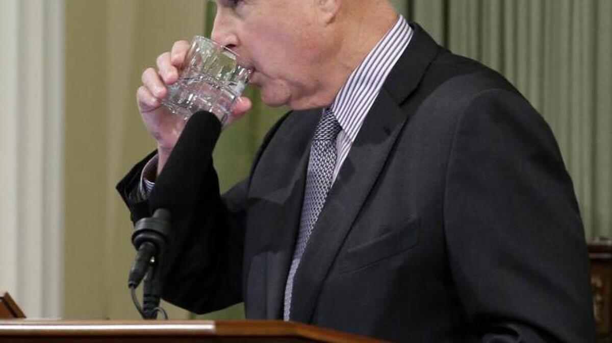 Gov. Jerry Brown pauses for a drink of water while giving his 2016 State of the State address.