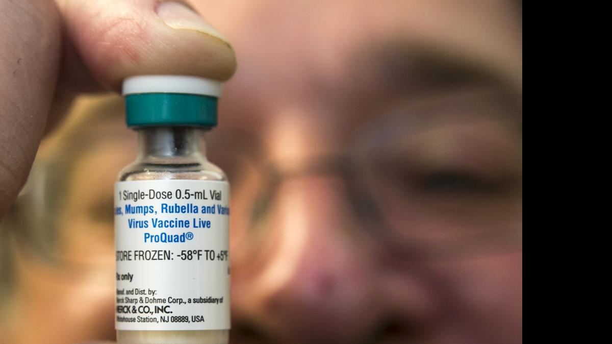 
A pediatrician holds a dose of the measles-mumps-rubella vaccine at his practice in Northridge.
