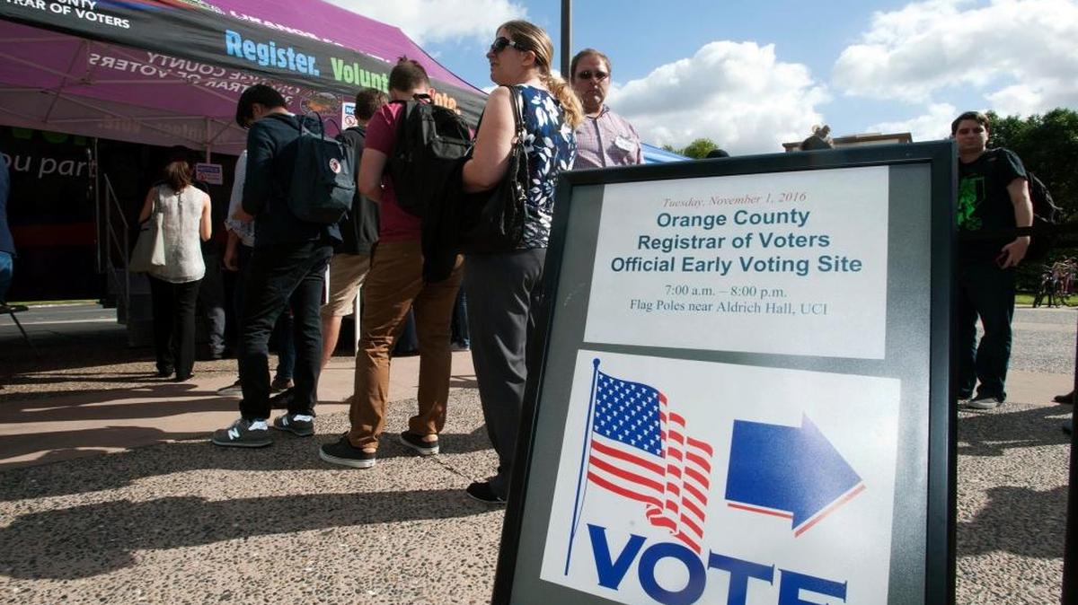 People line up at an early voting site at UC Irvine. California registration has surged.