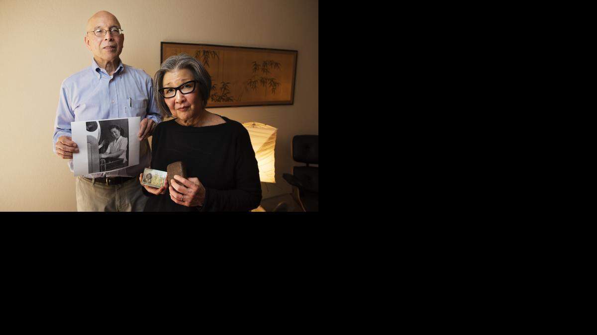 
Yoshinori Himel and his wife, Barbara Takei, hold internment camp relics of the sort being auctioned off by New Jersey-based Rago Arts and Auctions. Himel found his mother’s photo in one of the lots being auctioned, and they are leading a national campaign to stop the sale. 
