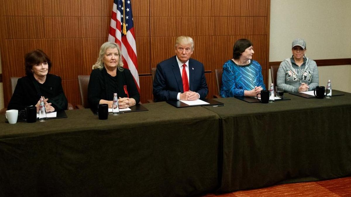 Donald Trump, center, sits with, from left, Kathleen Willey, Juanita Broaddrick, Kathy Shelton and Paula Jones before the second presidential debate with Democratic presidential candidate Hillary Clinton at Washington University on Sunday, Oct. 9, 2016, in St. Louis.