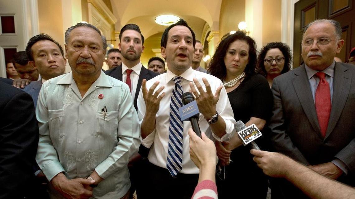 Assembly Speaker Anthony Rendon, D-Paramount, center, speaks to farmworkers and their supporters in the Capitol last week after postponement of a vote on farmworker overtime bill until Monday.