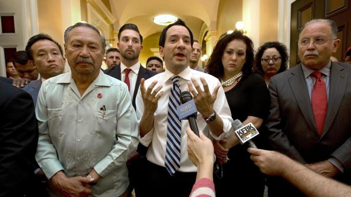 Assembly Speaker Anthony Rendon, D-Paramount, center, speaks to farmworkers and their supporters in the Capitol last week after postponement of a vote on farmworker overtime bill until Monday.