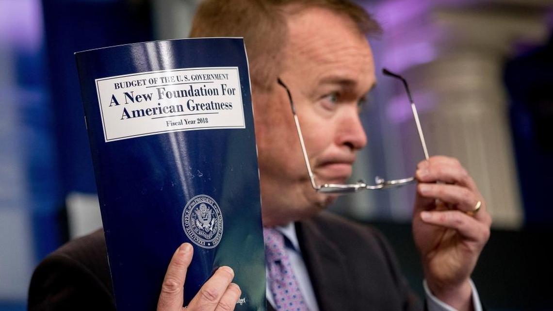 Budget Director Mick Mulvaney holds up a copy of President Donald Trump’s proposed fiscal 2018 federal budget as he speaks to members of the media in the Press Briefing Room of the White House in Washington on Tuesday, May 23, 2017.