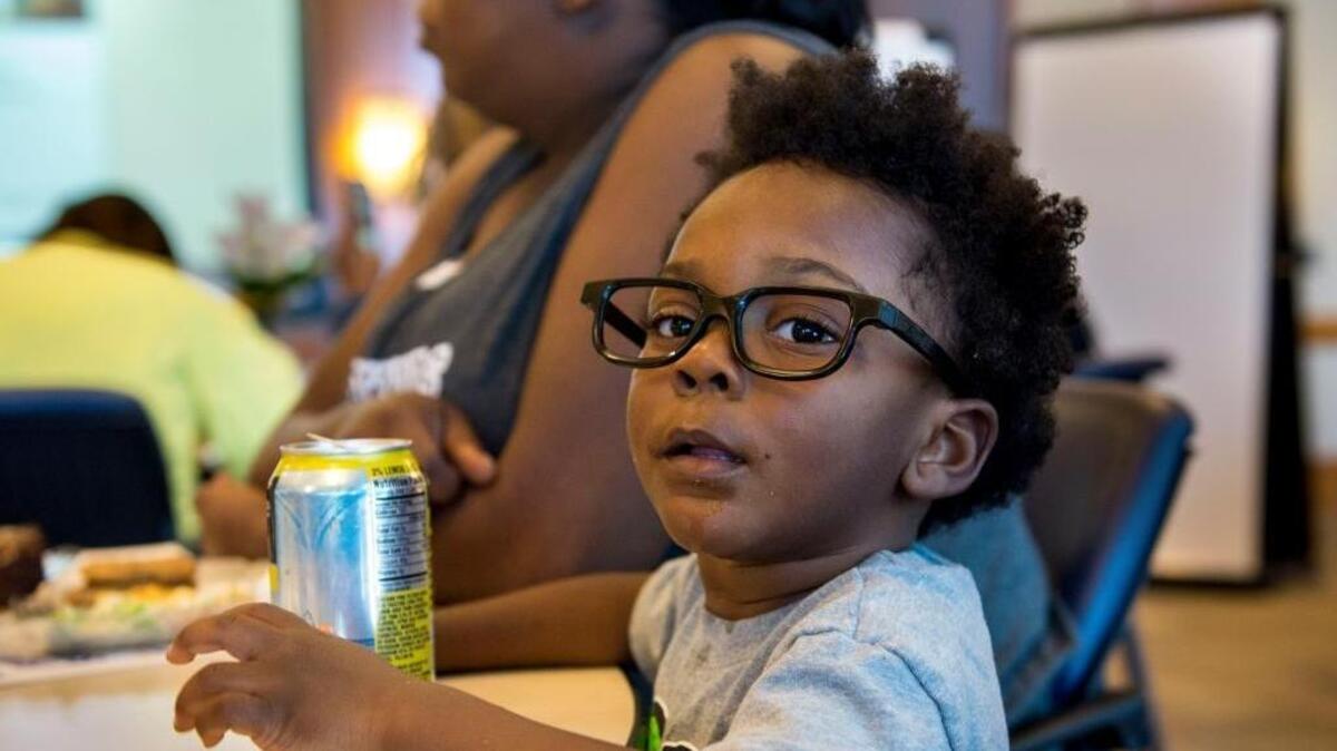Two-year-old Saigon McCoy sits with his mother, Stephanie Reid, as dozens of women gathered at the Sierra Health Foundation on March 17 to discuss how to reduce violence. Measure Y on the June 7 ballot would tax marijuana cultivation and set aside the revenue for children’s programs in Sacramento.