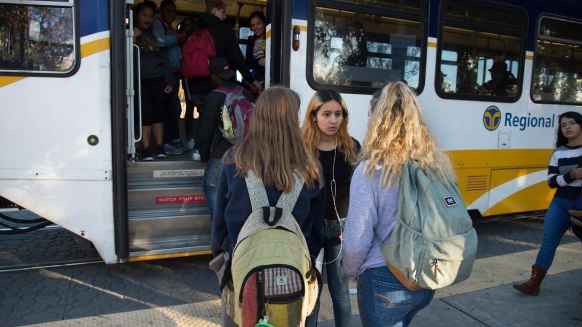 Kayla Argueta, a McClatchy High student, talks with friends before boarding a RT light rail train on Dec. 7.