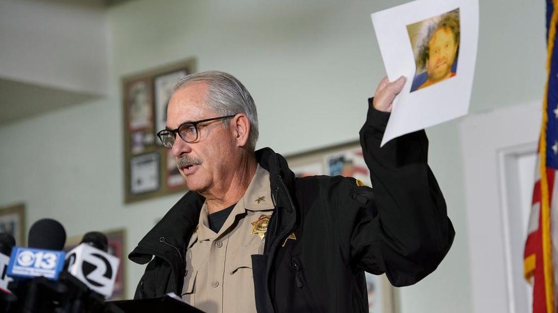 Tehama County Assistant Sheriff Phil Johnston displays a recent booking photo of the suspected gunman from Tuesday’s shooting rampage in Rancho Tehama Reserve.