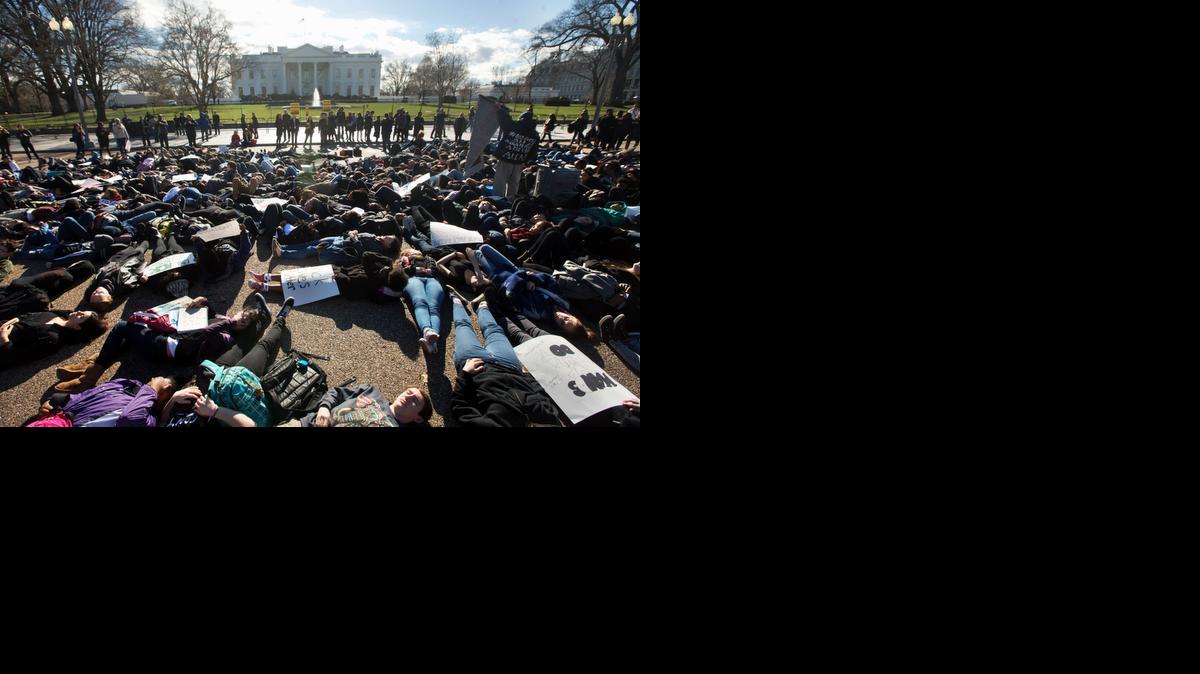 
Students from Washington D.C.’s “School Without Walls” lie down on Pennsylvania Avenue in front of the White House on Wednesday  after walking out of class to participate in a “die-in.” The students chanted “Hands up, don’t shoot,” as part of their protest against shootings by police. 
