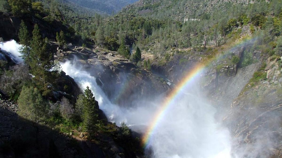 A rainbow forms in the mist from water releases at Hetch Hetchy Reservoir on the Tuolumne River in Yosemite National Park. Regulators want to leave more water in the river for wildlife, to the consternation of farmers and Bay Area customers.