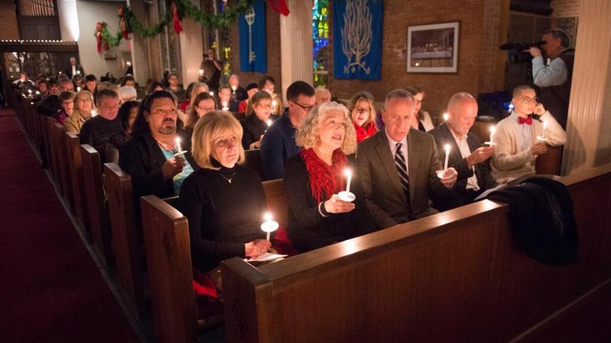 Mayor Darrell Steinberg, center, and other members of the community sing “Let There Be Peace on Earth” during the 3rd Annual Interfaith Homeless Memorial Service at Trinity Cathedral.