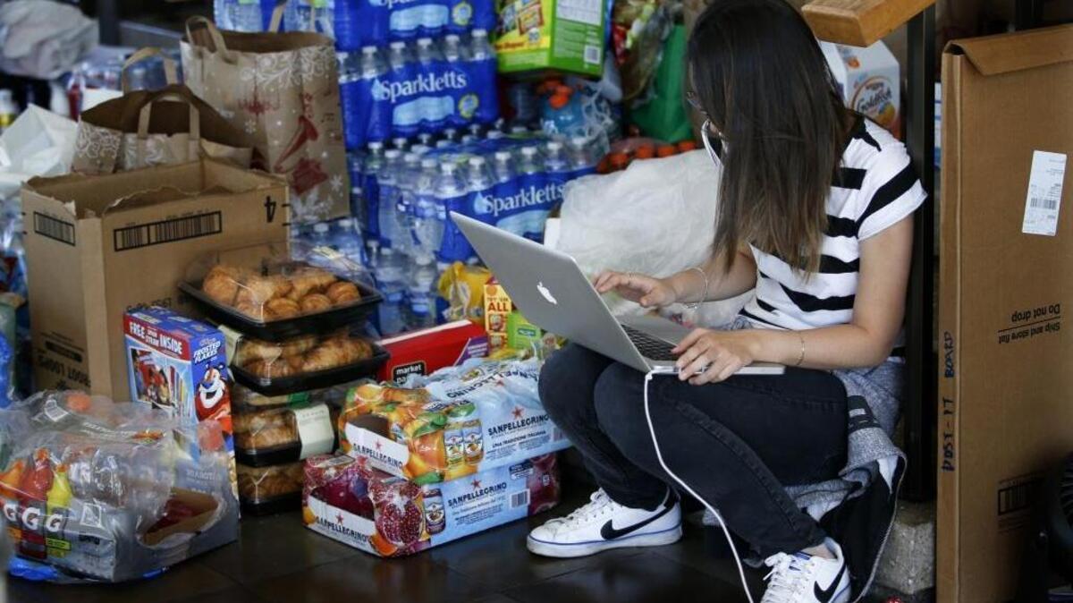 Erin Kim studies next to a stack of supplies and groceries on Nov. 17, the second day of occupation of Occidental College’s administrative building. Students were protesting the administration’s handling of complaints about diversity and discrimination.