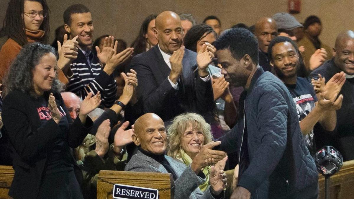 Comedian Chris Rock, center right, shakes hands with singer and social activist Harry Belafonte during a Martin Luther King holiday event Monday at the Riverside Church in New York. Rock, who is scheduled to host the Oscars Feb. 28, has called the ceremony “The White BET Awards.”