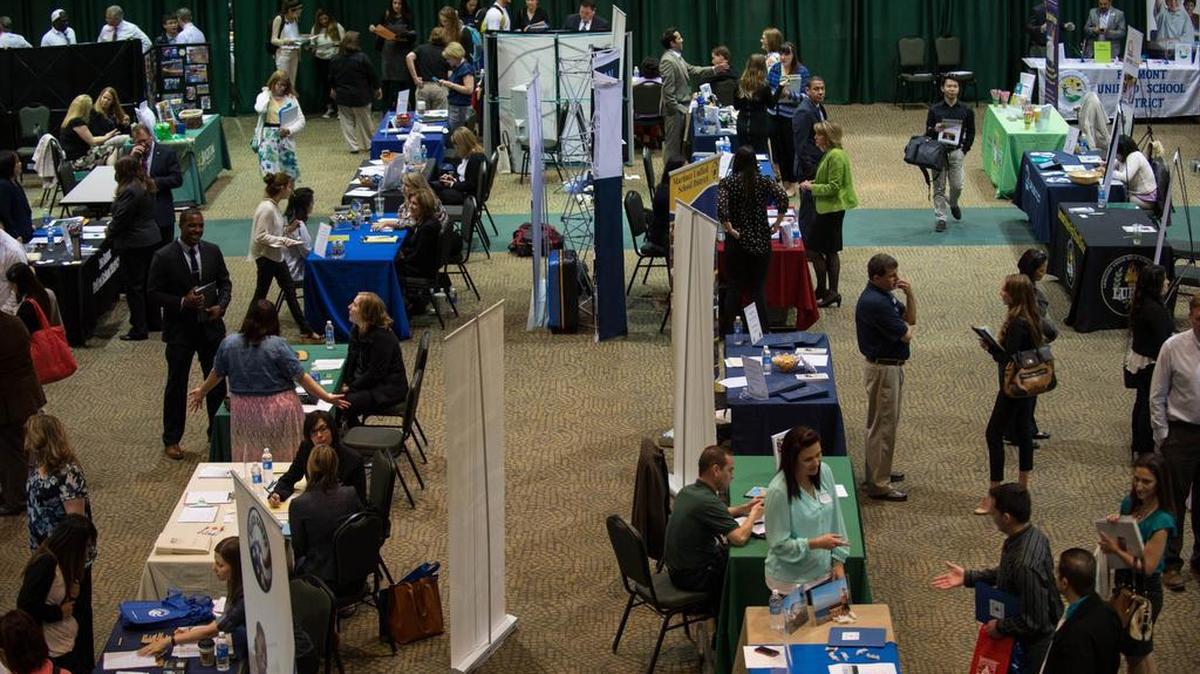 
School districts from around California interview teaching candidates at CSU Sacramento’s University Union ballroom. California is one of many states facing teacher shortages. 
