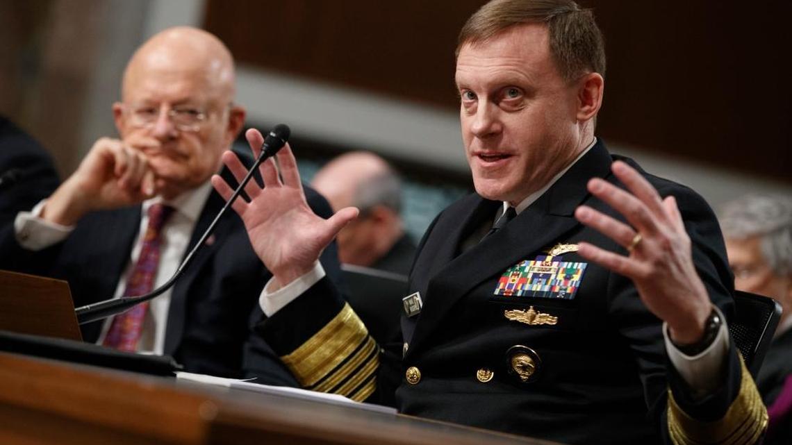 Director of National Intelligence James Clapper, left, listens as National Security Agency chief Adm. Michael Rogers testifies Thursday.