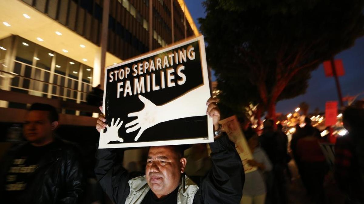 Dozens of people rally in downtown Los Angeles in February 2017 to protest raids by Immigrations and Customs Enforcement.