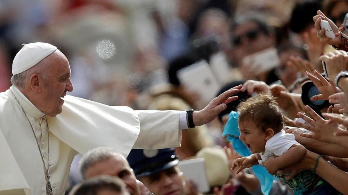 
Pope Francis blesses a child in St. Peter’s Square at the Vatican. He will visit the United States next week. 
