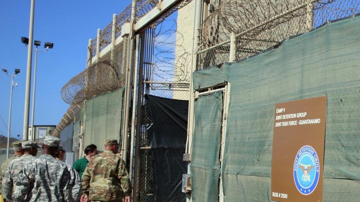 Military personnel enter the U.S. detention center at Guantanamo Bay, Cuba, in February. After the transfer of 15 detainees, 61 terrorist suspects remain after more than 14 years.