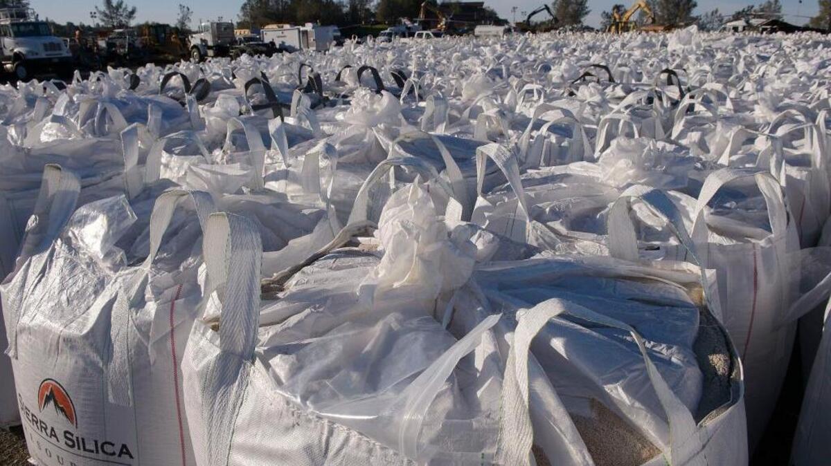 Huge bags of sand fill the overlook parking area in Oroville on Tuesday. Helicopters lifted and dropped them onto eroded areas of the emergency spillway hoping to mitigate more erosion from rain expected this weekend.