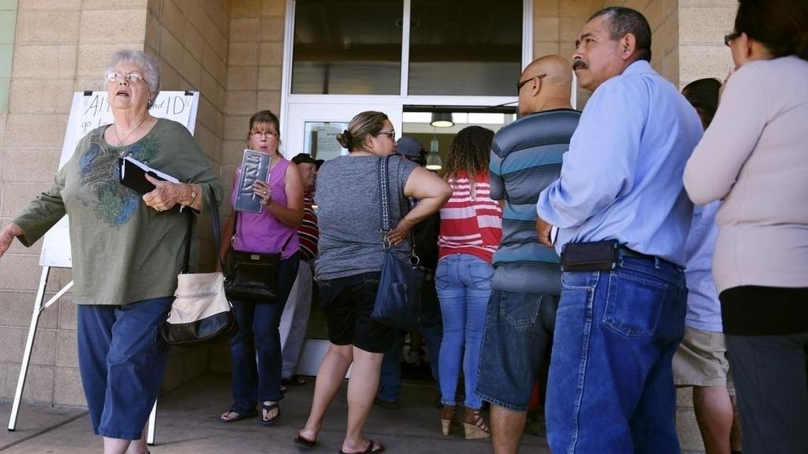Customers wait in line at the Olive Avenue DMV office in Fresno in June.